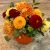 Floral arrangement with autumn colors staged in a hollowed-out pie pumpkin.