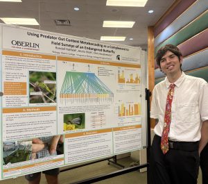 Randall Hatfield stands next to his research poster at the 2025 KBS Undergraduate Research Symposium.
