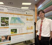 Randall Hatfield stands next to his research poster at the 2025 KBS Undergraduate Research Symposium.