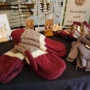 Close-up of merchandise, including mittens, socks, and earrings, from Saturdays with Ashley at the W.K. Kellogg Manor House Holiday Market.