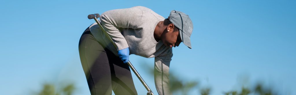 Dr. Christine Sprunger samples soil on a summer day.