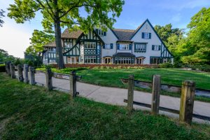 Photo of a sidewalk leading up the hill to the W.K. Kellogg Manor House, on a summer day. Credit to Kurt Stepnitz.