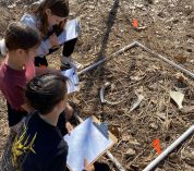 Fourth-grade students examine bones on the forest floor through a partnership with KBS staff and graduate students.