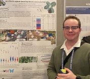 KBS graduate student Sam Stynen stands next to his research poster during a session at the British Ecology Society Conference in Edinburgh, Scotland, in winter 2025.